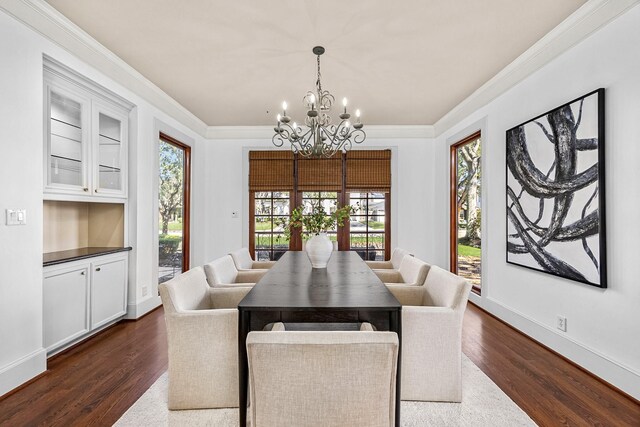 5105 Pocahontas St, Bellaire, TX 77401 - dining area with a chandelier, dark wood finished floors, healthy amount of natural light, crown molding, and baseboards