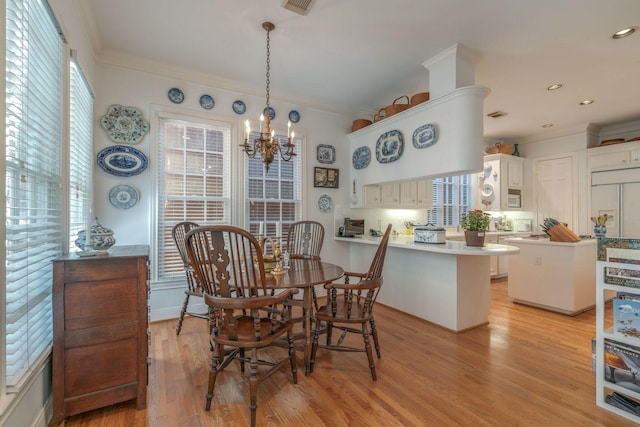 dining room with plenty of natural light, a chandelier, light wood-type flooring, ornamental molding, and recessed lighting