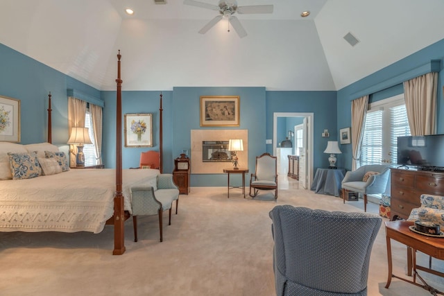 bedroom featuring high vaulted ceiling, light carpet, multiple windows, and ceiling fan