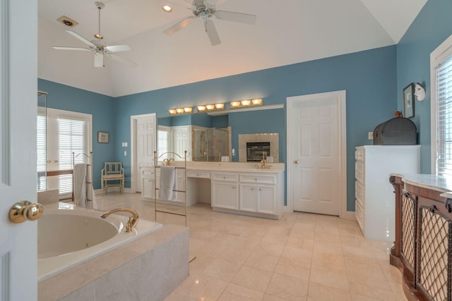 bathroom with a ceiling fan, a whirlpool tub, vanity, a stall shower, and high vaulted ceiling