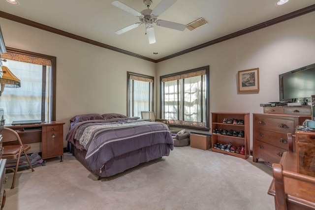 carpeted bedroom with ornamental molding and a ceiling fan