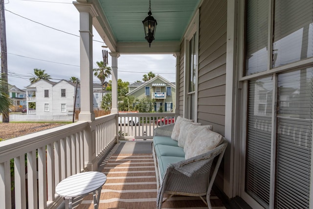 balcony featuring covered porch and a residential view