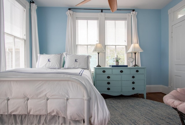 bedroom with wood finished floors and baseboards