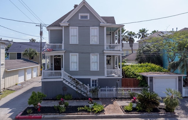 view of front facade featuring a balcony, an outdoor structure, and stairway