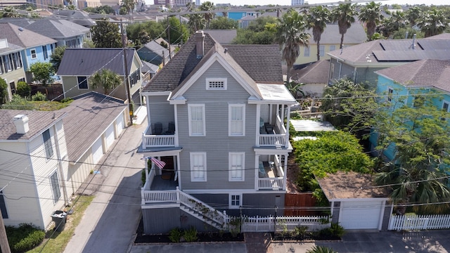 view of front of home featuring fence, a garage, and a residential view