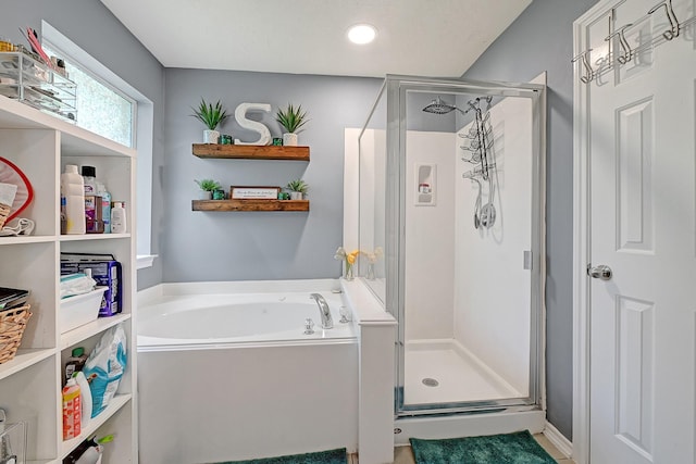 full bathroom with a stall shower and a garden tub