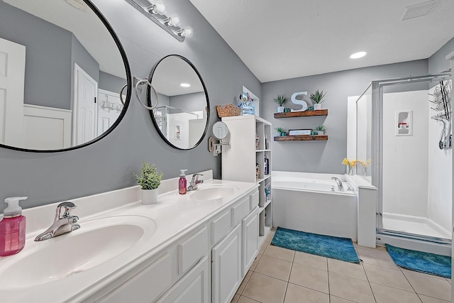 bathroom featuring a shower stall, tile patterned floors, a garden tub, and double vanity