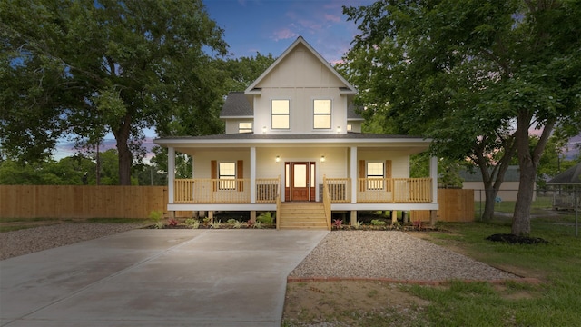 view of front facade with a porch and fence
