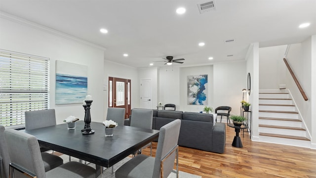 dining space featuring ornamental molding, light wood finished floors, recessed lighting, stairway, and ceiling fan