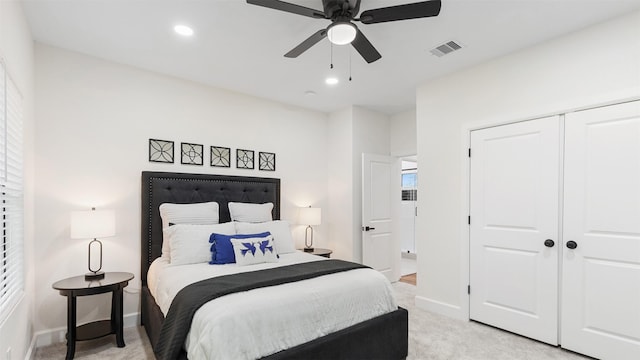 bedroom with light colored carpet, baseboards, a closet, recessed lighting, and a ceiling fan