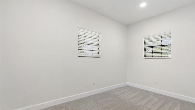 carpeted spare room with baseboards and recessed lighting