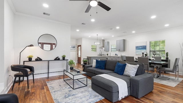living room featuring crown molding, ceiling fan, wood finished floors, recessed lighting, and baseboards