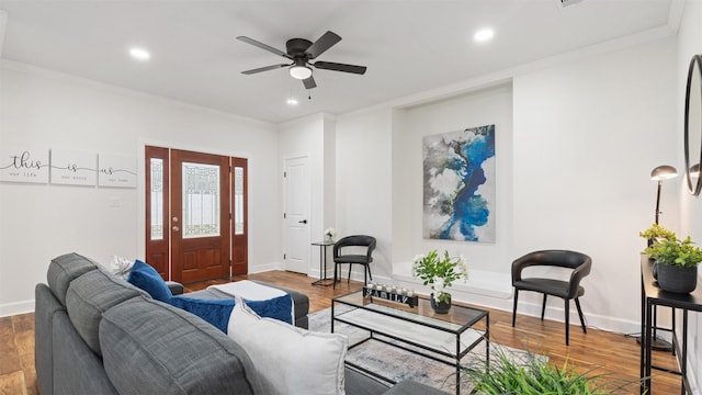 living room with ornamental molding, a ceiling fan, recessed lighting, wood finished floors, and baseboards