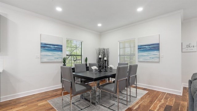 dining room featuring crown molding, wood finished floors, baseboards, and recessed lighting