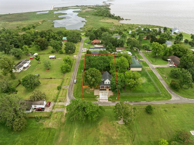 aerial view of property and surrounding area featuring a nearby body of water and property parcel outlined