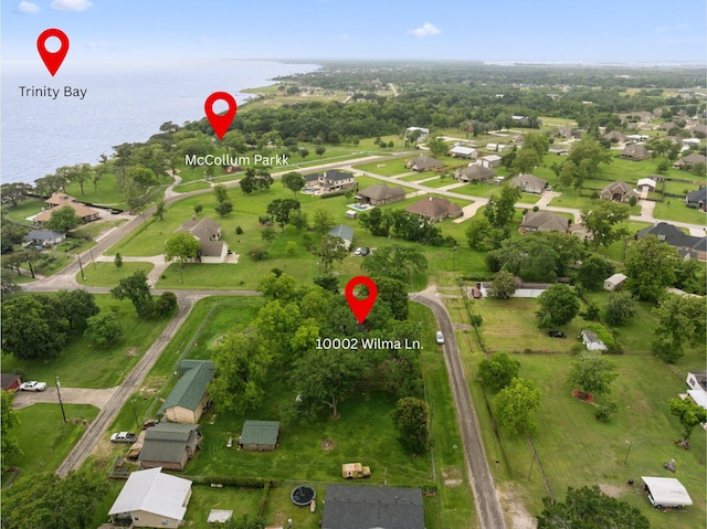 aerial view of property and surrounding area featuring a nearby body of water