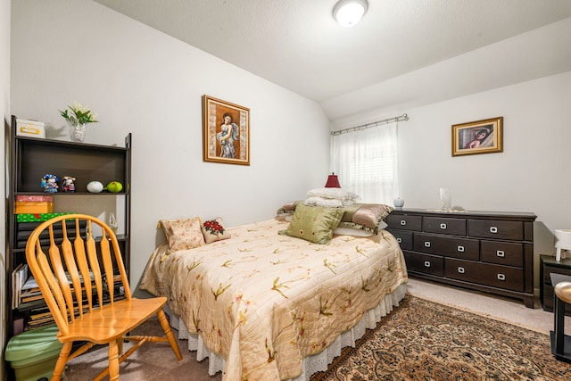 bedroom featuring lofted ceiling and carpet flooring