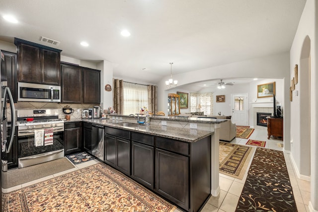 kitchen with stainless steel appliances, a sink, ceiling fan, a peninsula, and recessed lighting