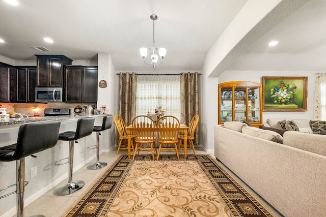 dining space with baseboards, a chandelier, light tile patterned flooring, and recessed lighting