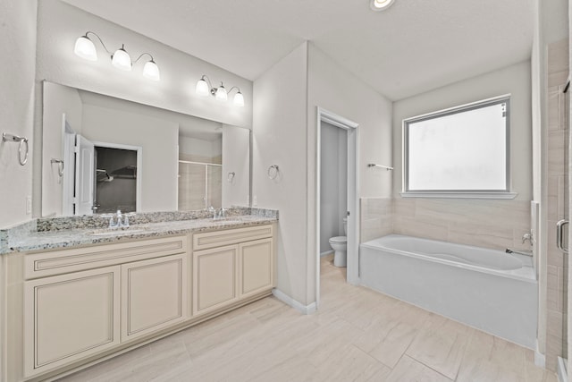 15423 Hopkins Cedar Dr, Humble, TX 77346 - bathroom with a shower stall, toilet, double vanity, a bath, and baseboards