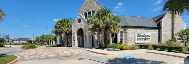 15423 Hopkins Cedar Dr, Humble, TX 77346 - view of front of home with stone siding and a high end roof