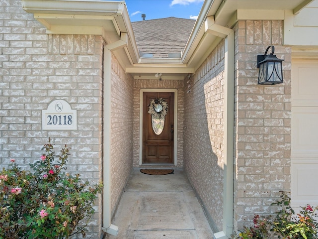 20118 Lakespire Dr, Katy, TX 77449 - view of exterior entry featuring brick siding and a shingled roof