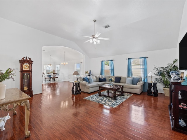 20118 Lakespire Dr, Katy, TX 77449 - living room featuring arched walkways, a ceiling fan, wood finished floors, a chandelier, and high vaulted ceiling