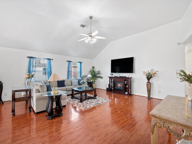 20118 Lakespire Dr, Katy, TX 77449 - living room with lofted ceiling, ceiling fan, wood finished floors, a glass covered fireplace, and baseboards
