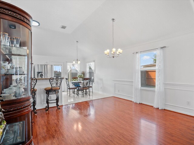 20118 Lakespire Dr, Katy, TX 77449 - dining area featuring a chandelier, wood finished floors, and vaulted ceiling