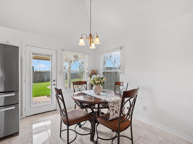 20118 Lakespire Dr, Katy, TX 77449 - dining room featuring a chandelier, healthy amount of natural light, light tile patterned floors, and baseboards