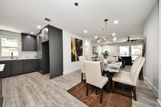 dining area featuring baseboards, light wood-type flooring, plenty of natural light, and recessed lighting