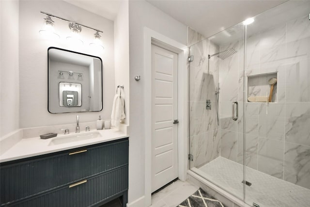 bathroom featuring marble finish flooring, vanity, and a marble finish shower