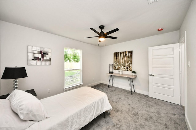carpeted bedroom with baseboards and a ceiling fan
