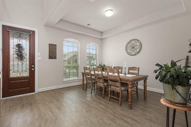 2510 Ocean Key Dr, Texas City, TX 77568 - dining room with wood finished floors, baseboards, and a tray ceiling