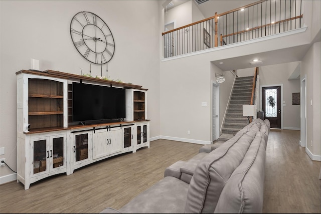 2510 Ocean Key Dr, Texas City, TX 77568 - living area with wood finished floors, stairway, baseboards, and a high ceiling
