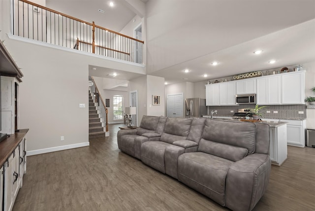 2510 Ocean Key Dr, Texas City, TX 77568 - living room with wood finished floors, stairs, a high ceiling, baseboards, and recessed lighting