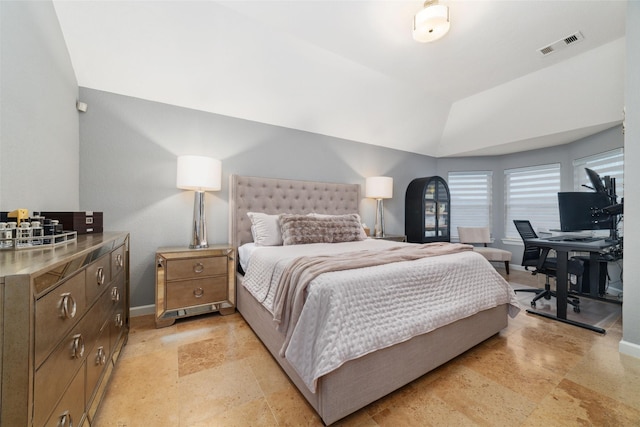 bedroom featuring lofted ceiling, a desk, and baseboards