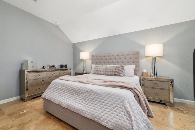 bedroom featuring baseboards and vaulted ceiling