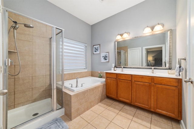 full bath featuring tile patterned floors, a stall shower, a garden tub, and double vanity