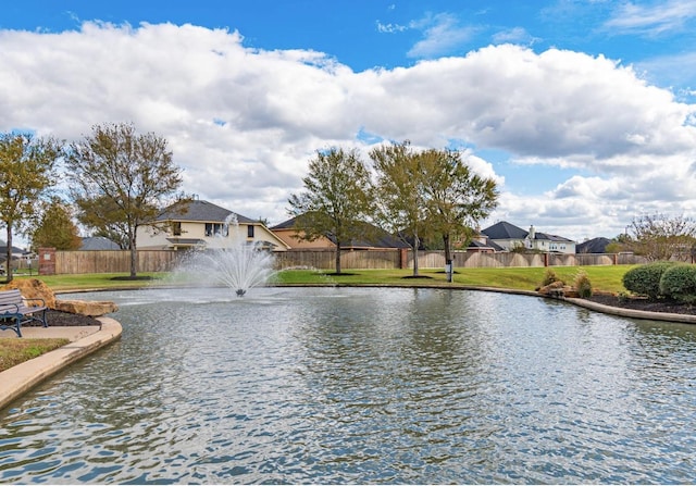 water view with fence and nearby suburban area