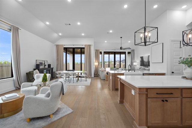 4826 Hudson Park Ct, Fulshear, TX 77441 - kitchen with open floor plan, ceiling fan, light countertops, light wood-style flooring, and recessed lighting