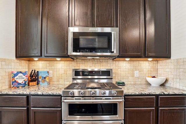 3519 Barkers Run Dr, Houston, TX 77084 - kitchen with stainless steel appliances, dark brown cabinets, and tasteful backsplash