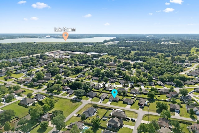 aerial view of property's location with a large body of water and nearby suburban area