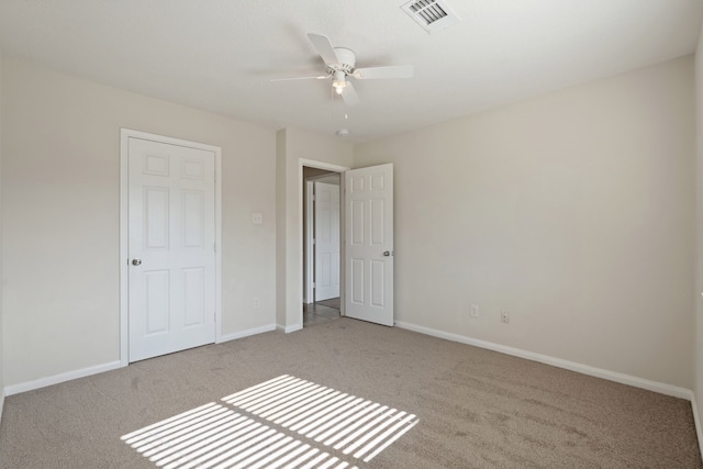 unfurnished bedroom with carpet flooring, baseboards, and a ceiling fan