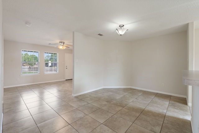 unfurnished room featuring light tile patterned floors, a ceiling fan, baseboards, and a smoke detector