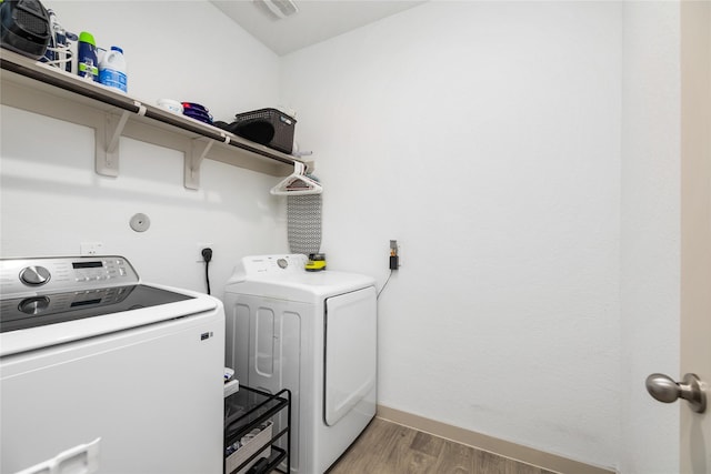 502 Rain Cloud Dr, Baytown, TX 77523 - washroom with independent washer and dryer, light wood finished floors, and baseboards