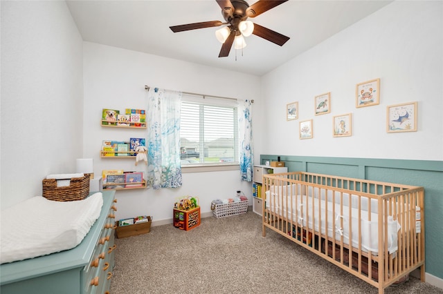 502 Rain Cloud Dr, Baytown, TX 77523 - bedroom featuring a nursery area, carpet floors, ceiling fan, and baseboards