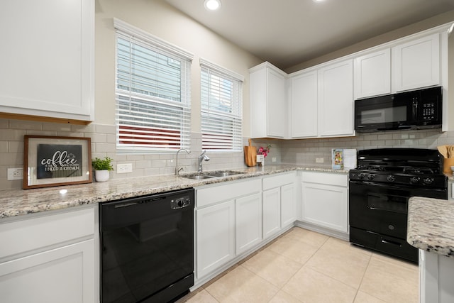 11707 Finnick Bend Dr, Tomball, TX 77377 - kitchen featuring black appliances, a sink, tasteful backsplash, light tile patterned floors, and white cabinetry