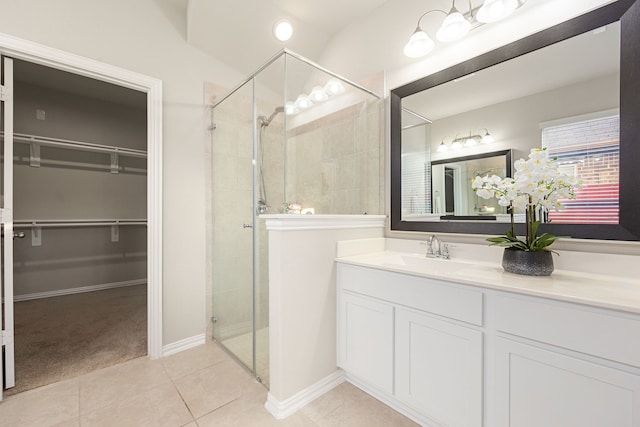 11707 Finnick Bend Dr, Tomball, TX 77377 - full bath with a shower stall, a spacious closet, vanity, tile patterned flooring, and baseboards
