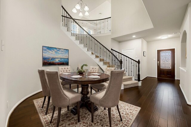 11707 Finnick Bend Dr, Tomball, TX 77377 - dining area with stairway, a chandelier, dark wood finished floors, baseboards, and a high ceiling